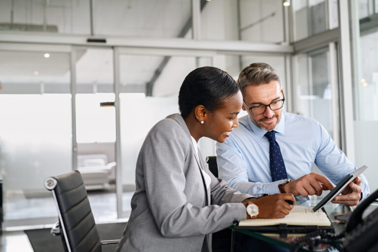 two colleagues working together in office